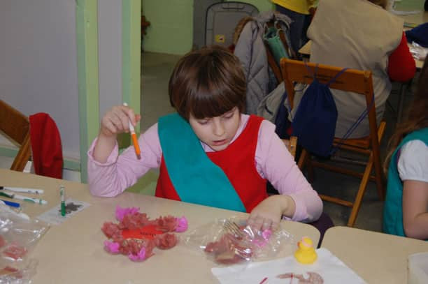 girl making teddy bear craft for valentines day